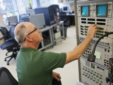 man presses buttons on a large machine